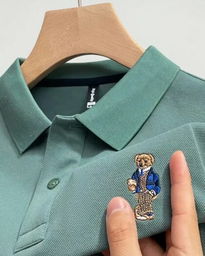 Polo vert avec broderie sur un ceintre.